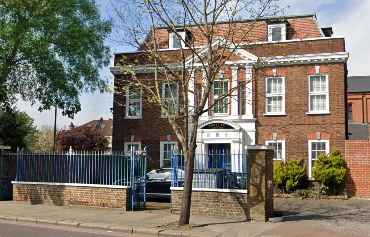 The Presbytery, 96 North Side, Wandsworth: a Neo-Georgian red-brick house with a white pedimented centre, behind blue railings